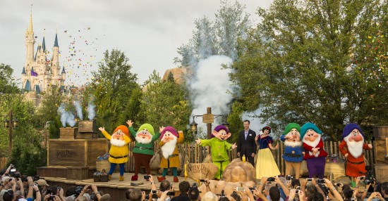LAKE BUENA VISTA, FL - MAY 02:  In this handout photo provided by Disney Parks, Tom Staggs, chairman of Walt Disney Parks & Resorts, joins Snow White the Seven Dwarfs to dedicate the park's newest attraction, the Seven Dwarfs Mine Train, May 2, 2014 in the Magic Kingdom park at Walt Disney World Resort in Lake Buena Vista, Florida.  The attraction, which will open to guests May 28, is a family-style coaster that immerses guests in playful and musical scenes inspired by the Disney animated classic film, "Snow White and the Seven Dwarfs."  The attraction completes New Fantasyland, the largest expansion in the history of the Magic Kingdom. (Photo by Matt Stroshane/Disney Parks via Getty Images)
